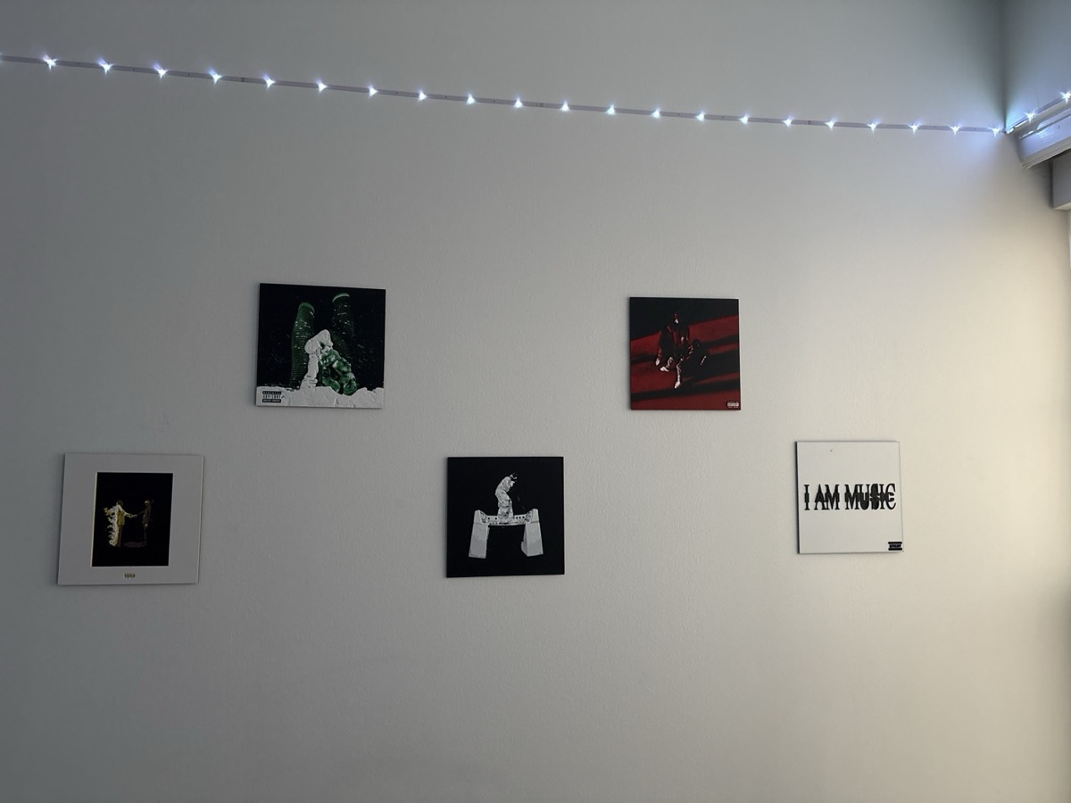 Five 3D printed album covers hung on a wall